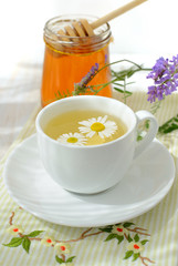 Herbal tea and a jar of honey.