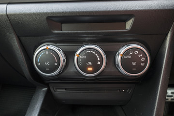 Fototapeta premium Detail with the air conditioning button inside a car.