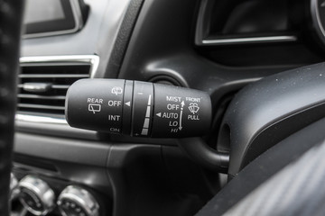 Detail of the wind screen wipers button, in a car.