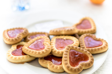 heart shaped cookies on a white plate in the foreground