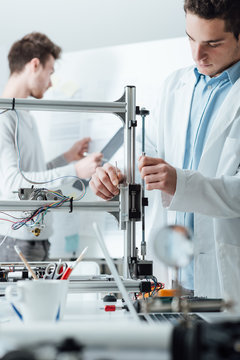 Engineers in the lab using a 3D printer