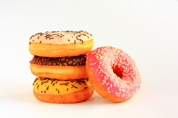 Four donuts with yellow, brown, white and red icing