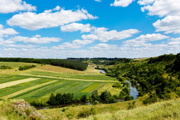 Fototapeta na wymiar beautiful summer landscape of river in the valley, fields and fo