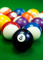billiard balls on a green pool table, closeup