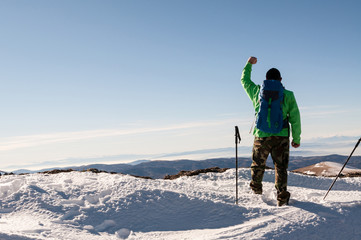Fototapeta na wymiar Cheerful man hiker on top of mountain