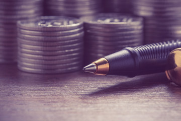 money concept coins and pen with filter effect retro vintage sty