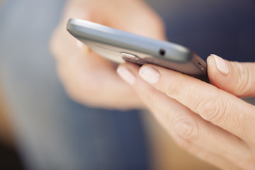 Close up of a woman using mobile smart phone