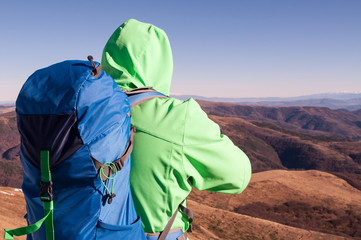 Hiker looking at the mountain scenery from the top