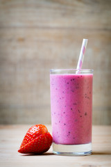 Smoothie, pink juice on the grey  background.