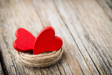 Red heart-shaped on a wooden background.