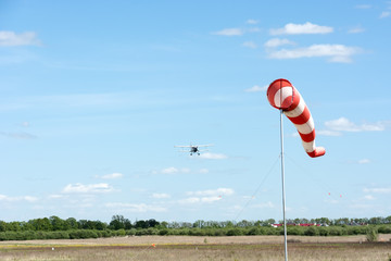 Windsock against cloudy sky.