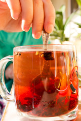 tea in a transparent mug with spices