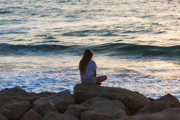 woman sitting on seashore