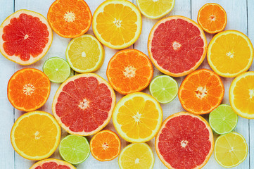 Citrus fruits. Oranges, limes, grapefruits, tangerines and lemons. Over white wood table background with copy space. Top view