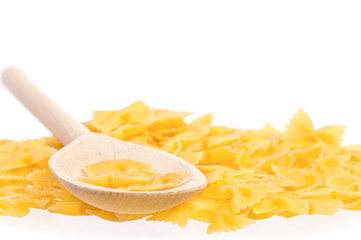 Raw pasta with wooden spoon