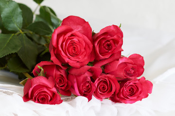 Red roses on a white dress - series of red roses