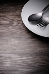 a set of cutlery on wooden background