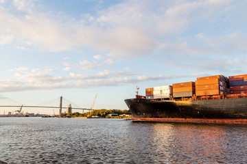 Naklejka premium Full Freighter Heading Toward Bridge