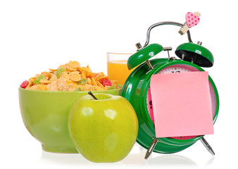 Big green alarm clock with breakfast