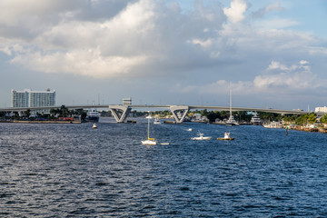 Sailboats by Bridge Under Storm Clouds