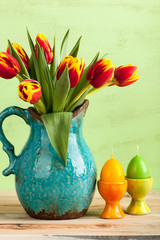 Colorful tulips and Easter egg candles