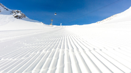 Newly groomed ski slope on a sunny day
