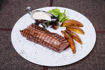 Delicious beef steak with roasted potatoes.