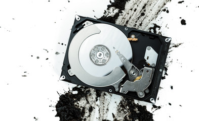 Open computer hard disk drive on muddy background