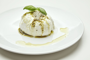 Mozarella with pesto isolated on white