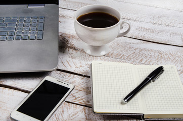 Coffee table with laptop and notebook