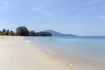 Beach, blue sea and white sands of Mai Khao Beach, Phuket, Thailand.