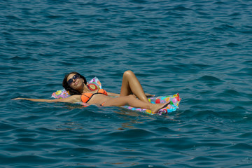 woman on air mattress in the sea