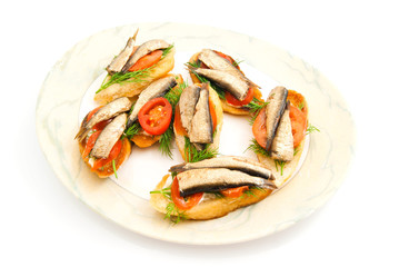 sandwiches with sprats on plate