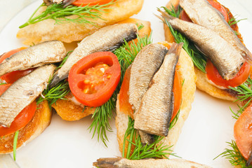 sandwiches with sprats on dish