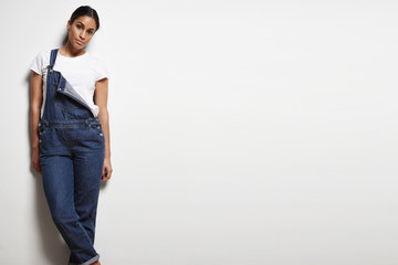 woman wears overalls on a white background
