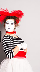 A woman clown mime posing in studio, april fools day concept