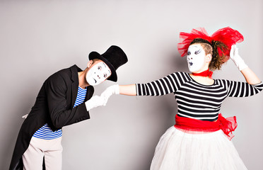 portrait of mimes in love. man kissing womans hand