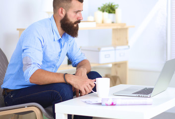 Young businessman sitting on chair in office