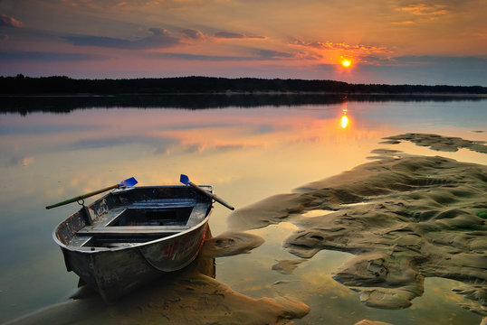 Sand moored boat on sunrise