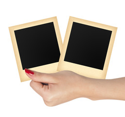 Two old photo papers card in woman hand isolated on white