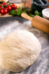 Rolling pizza dough with wooden roller