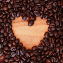 Coffee beans on wood background
