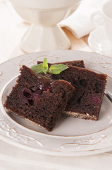 chocolate brownie with walnuts on a white plate  