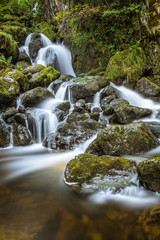 Fototapeta premium Trickling water flowing through rocks at Lodore Falls in Keswick, Lake District, UK. 