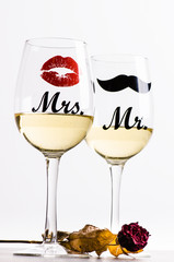 Two wine glasses with wine isolated on a white background. Glasses for woman and man. White wine. Happy lifestyle. Romantic. Rose. Pour a wine. Valentines background