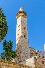 Fototapeta premium Omer mosque minaret in front of the Church of the Holy Sepulchre in Jerusalem, Israel.