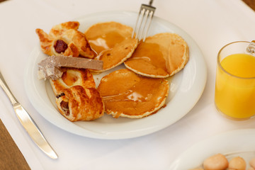 breakfast Fresh bread rolls, pancakes honey Turkish sweets, orange juice