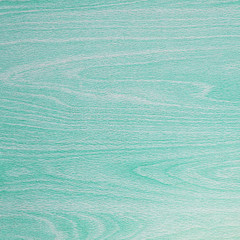 Pastel light turquoise background texture, wood grain patterns.