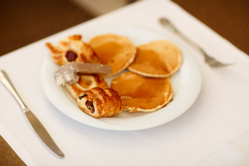 breakfast Fresh bread rolls, pancakes honey Turkish sweets, orange juice