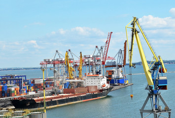 Container stack and ship under crane bridge